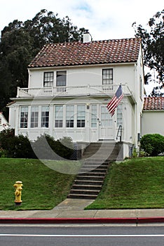 A classic American house with the flag of the United States.