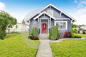 Classic American house with siding trim and red entry door