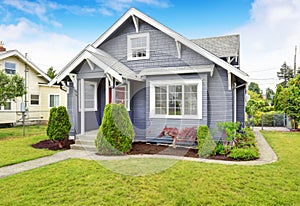 Classic American house with siding trim and red entry door