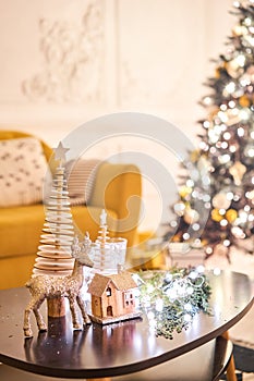 Classic apartments with decorated christmas tree and presents. Christmas evening in the light of candles and garlands