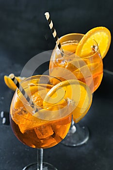Classic aperol spritz cocktail in glass on black table. Close up.
