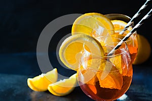 Classic aperol spritz cocktail in glass on dark. Close up.