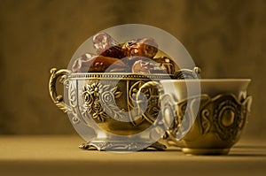 Classic Arabic teacups and a bowl of dates