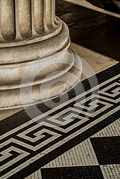 Classic architectural detail of support column and mosaic tiling.