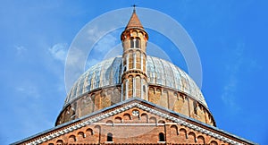 Classic architecture and St. Antony cathedral building with towers and dome against blue sky in Padua, Italy