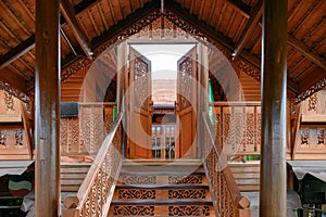 Classic asian wooden house with carving door opening