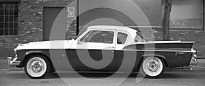 Classic automobile in a parking area. Black and white