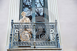 Classic balcony with a statue in Athens, Greece