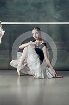 The classic ballerina posing at ballet barre