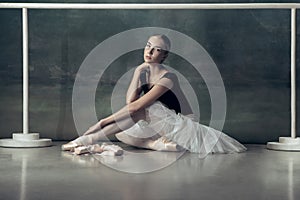 The classic ballerina posing at ballet barre