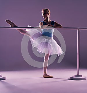 Classic ballerina posing at ballet barre