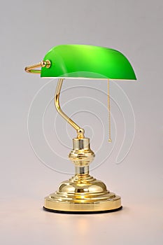 Classic Banker desk lamp with gold pull chain isolated on white background