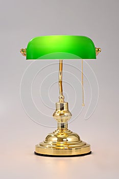 Classic Banker desk lamp with gold pull chain isolated on white background