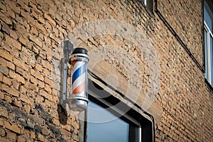 Classic Barber Shop Pole on Brick Wall