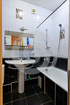 Classic bathroom interior in an apartment, with black and white tiles