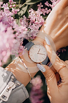 Classic beautiful white watch on woman hand. Close-up photo