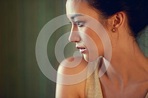 Classic beauty. Profile shot of a beautiful young woman dressed elegantly indoors.