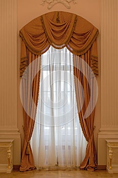 Classic beige curtain hanging on a window