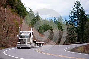 Classic big rig semi truck with step down semi trailer turning o