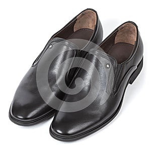 Classic black leather men's boots with a brown insole with a thin heel on a white background