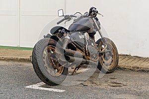 Classic black motorcycle parked by the roadside