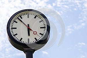 Classic black and white analog clock with correct time shows teamwork and synced project management with time management and deadl