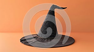 Classic black witch hat on an orange background