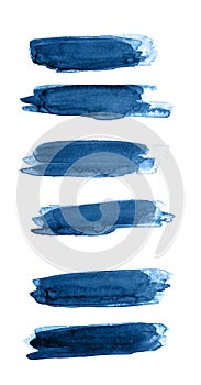 Classic blue color of year 2020 strokes of watercolor paint of different sizes on a white isolated background.