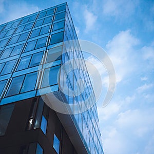 Classic blue glass office futuristic building in the city centre till the sky