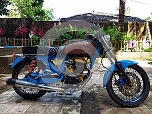 classic blue motorbike in the parking lot