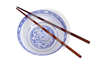 Classic blue pattern empty Chinese rice bowl with wooden chopsticks isolated on white