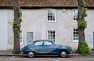 Classic blue Saab car parked on a residential street in Brentford, West London, UK.