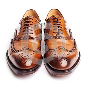 Classic brown leather brogue shoes with wingtip design, isolated on white background.