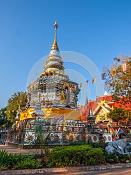 Classic Buddhism pagoda in Thai temple in Chiangrai, Thailand, under clear blue sky