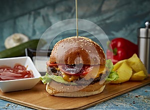 Classic burger with ketchup on a textured background