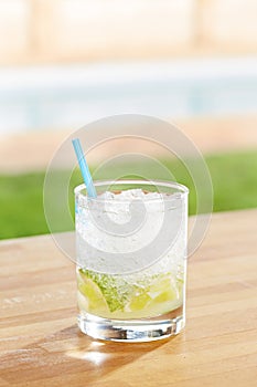 Classic caipirinha cocktail by a pool outdoors