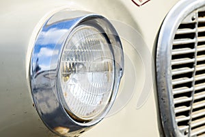 Classic car with close-up on headlights or Headlight lamp of retro car vintage style