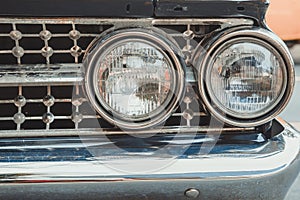 Classic car with close-up on headlights or Headlight lamp of retro car vintage style