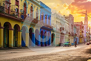 Classic car and colorful buildings  in Havana at sunset