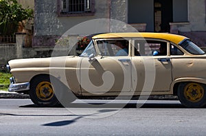 A classic car driver on the street in havana city