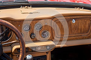 Classic car interior - Wooden steering wheel and dashboard