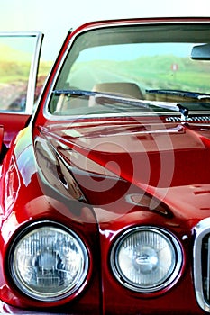 Classic  car. Red car. View of the rear seat in brown leather. Close up. High-end car. Collectable. Vehicle. Conveyance. Rea