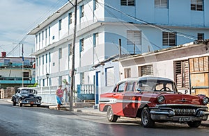 Classic cars with buildings in Santa Clara Cuba