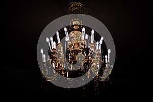 Classic chandelier isolated on black background lighten up