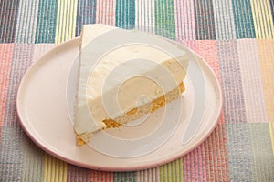 Classic cheesecake on white plate on  wooden table