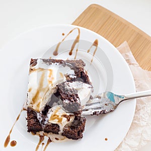 Classic chocolate dessert with a cup of coffee - brownies and ice cream