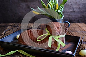 Classic chocolate Easter lamb pound cake sprinkled with cocoa powder