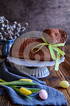 Classic chocolate Easter lamb pound cake sprinkled with cocoa powder