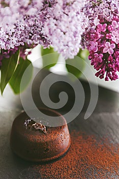 Classic chocolate fondant on a dark background with flowers