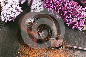 Classic chocolate fondant on a dark background with flowers